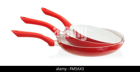 Set di tre spatole da cucina rosse e bianche in silicone e plastica isolate  su una superficie arancione utensile da cucina e pasticceria