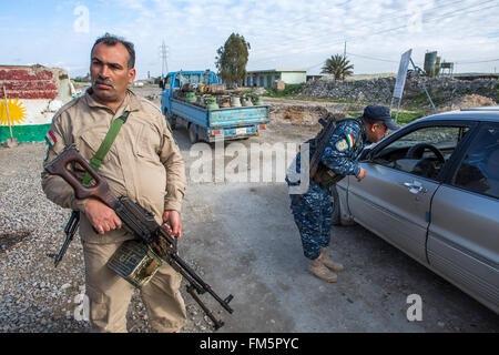 Combattente curdo in un posto di controllo stradale nei pressi della frontline con è nel nord Iraq Foto Stock