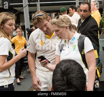 La squadra australiana del grillo Australia Brisbane con supporti e sostenitore femmina guardando al telefono Foto Stock