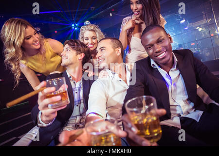 Happy amici con in mano un bicchiere di alcool Foto Stock