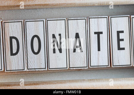 Donare la parola scritta su legno Foto Stock