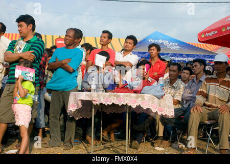 Una folla di tifosi guardare due Muay Thai boxer in un anello di boxe in un festival Kampong Cham, Cambogia. Foto Stock