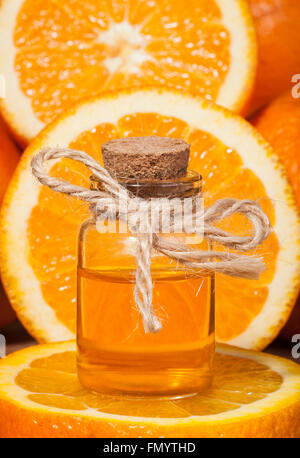 Bottiglia di olio essenziale di arance su sfondo di legno - medicina alternativa Foto Stock