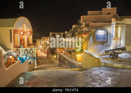 SANTORINI, Grecia - 4 ottobre 2015: la strada di Oia con i negozi di souvenir e ristoranti di notte. Foto Stock