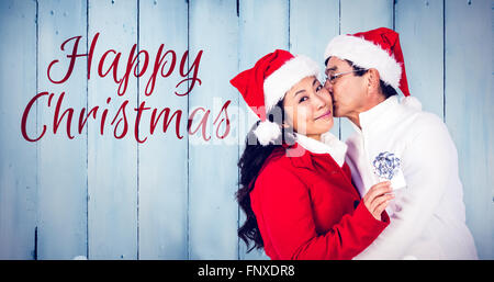 Immagine composita di festosa coppia senior lo scambio di doni Foto Stock