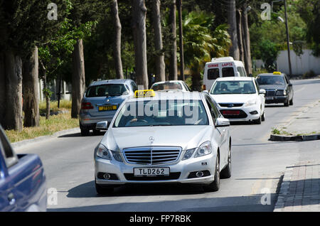 Taxi Mercedes guidando lungo una strada nella città di Kyrenia, la parte settentrionale di Cipro. Foto Stock