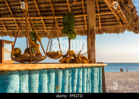 Nella foto il bar sulla spiaggia di Nungwi ( Zanzibar ) al tramonto , con esposto il cocco , banana e frutta tropicale .Questa barra è realizzata w Foto Stock