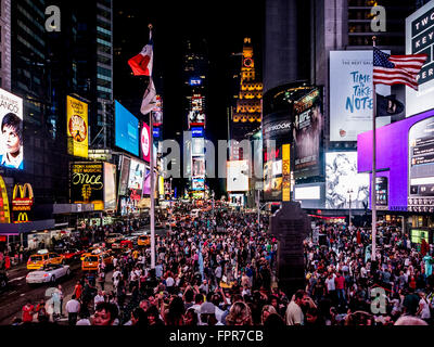 La folla di persone in Times Square di notte, la città di New York, Stati Uniti d'America. Foto Stock