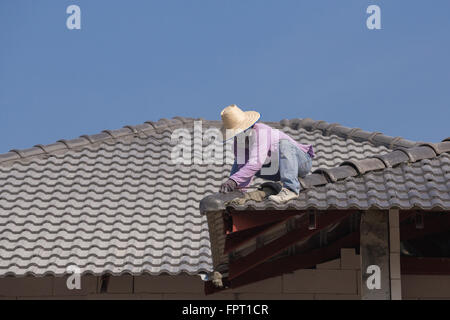 Lavoratori edili installazione di tegole del tetto per la costruzione di casa Foto Stock