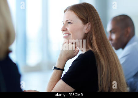 Fiducioso imprenditrice ascolto in riunione Foto Stock