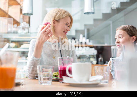 Madre e figlia di mangiare al tavolo del bar Foto Stock