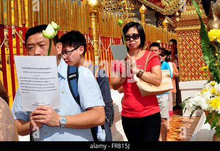 Chiang Mai, Thailandia: Thais devota preghiera porta carte e Lotus boccioli di fiori in processione al Wat Doi Suthep Foto Stock