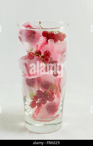 Frutti di bosco con cubetti di ghiaccio contro soft sfondo rosa Foto Stock