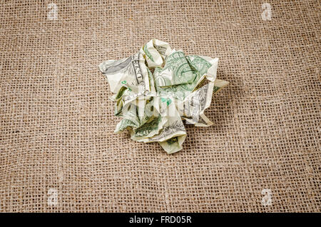 US dollar banconote accartocciate sul rustico sfondo di iuta Foto Stock
