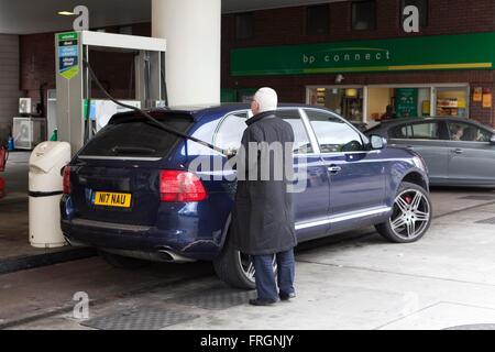 Un uomo si riempie il suo serbatoio di benzina presso la stazione di benzina BP sulla Wellington Road, Londra Foto Stock