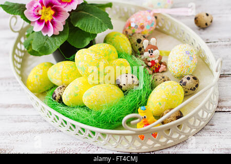 Uova di Pasqua e fiori su una luce sullo sfondo di legno Foto Stock