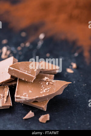 Il cioccolato al latte (messa a fuoco selettiva) su una lastra di ardesia (close-up shot) Foto Stock