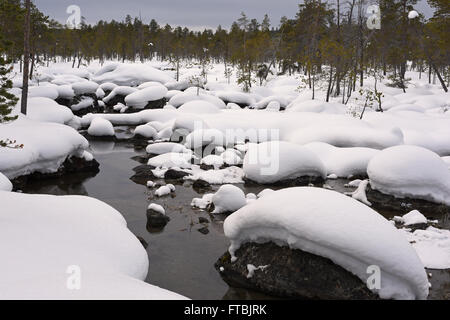 Paesaggio invernale lungo un parzialmente frozen river a Nellim, Lapponia, Finlandia Foto Stock