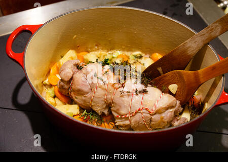 Carne di agnello arrotolato con gamba chump in una pentola con le verdure , timo e rosmarino Foto Stock