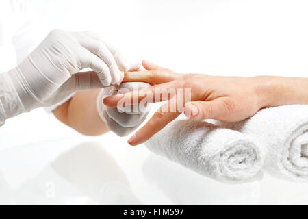 Rimozione di smalto per unghie manicure.. Estetista rimuove smalto per unghie con un batuffolo di cotone imbevuto di acetone. Foto Stock