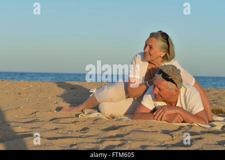 Coppia matura rilassante sulla spiaggia Foto Stock