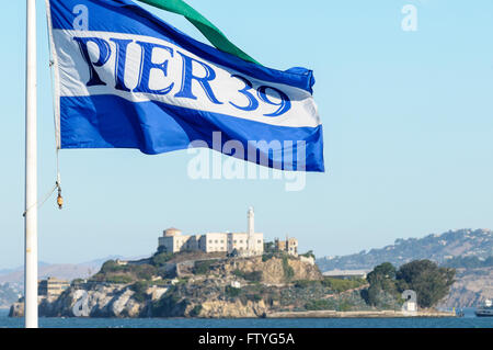 Pier 39, San Francisco bandiera con la prigione di Alcatraz in background Foto Stock