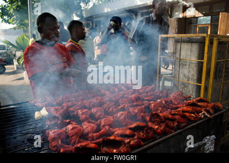 Cucina di strada in stallo. Fast food. Pollo alla griglia ala vendita a giardini di Forodhani grazia il lungomare di fronte a Beit al-ajaib, Casa Foto Stock