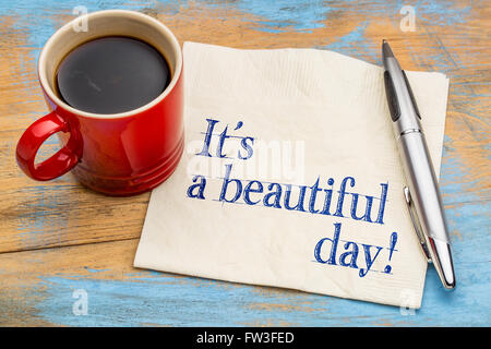 È una bella giornata! Scrittura su un tovagliolo con una tazza di caffè - buon umore concept Foto Stock