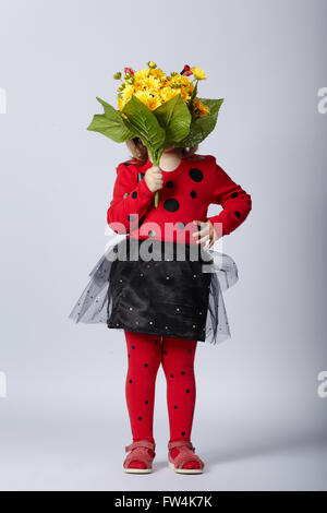 Poco funny girl in costume coccinella Foto Stock