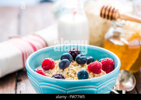 Porridge di avena wirh estate frutti di bosco e miele. Colazione sana nozione. Foto Stock