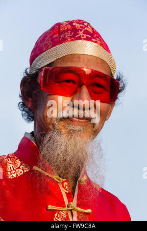 Ritratto, il vecchio uomo cinese con bicchieri rossi, Cappello e barba, nuovo anno cinese, il Festival di Primavera, Chinatown, Bangkok, Thailandia Foto Stock