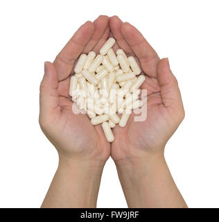 Un sacco di pillole in mani su sfondo isolato Foto Stock