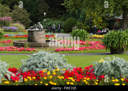 Giardini della valle, Harrogate, nello Yorkshire, Inghilterra - splendido parco con vivaci e colorati di aiuole, fontana e persone rilassante. Foto Stock