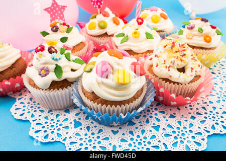 Tortini di compleanno con palloncini su uno sfondo blu. Foto Stock