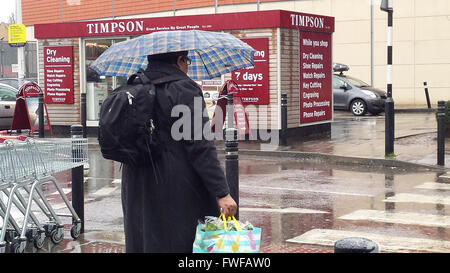 North London 4 Aprile 2016 - gli acquirenti ottenere catturati nella pioggia torrenziale nel pomeriggio con asciutto e soleggiato previsioni meteo per il sud-est per il resto della settimana. Credito: Dinendra Haria/Alamy Live News Foto Stock