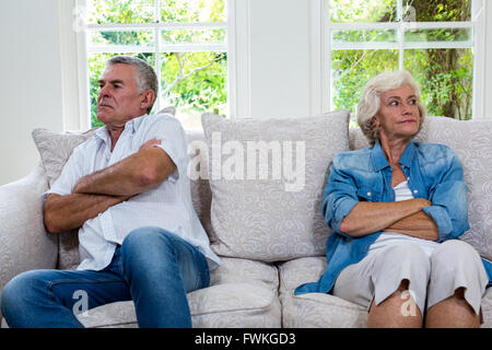 Infastiditi coppia senior che guarda lontano mentre è seduto sul divano Foto Stock