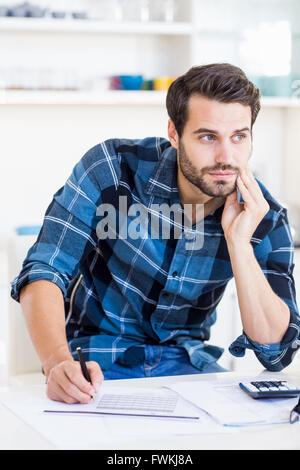 Un imprenditore è in posa e in possesso di una penna in mano Foto Stock