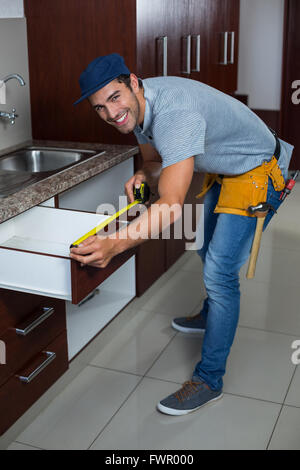 A piena lunghezza ritratto dell'uomo misurare dimensioni cassetto Foto Stock