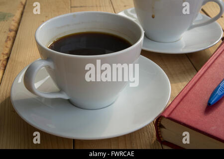 Tazza di caffè al mattino con prenota pen Foto Stock