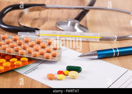 Medical pillole, compresse o supplementi per terapia, prescrizione, termometro e stetoscopio sulla scrivania in ufficio medico, Foto Stock