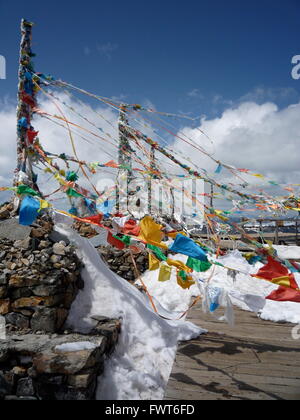 Preghiera tibetano bandiere sulla cima della montagna alla neve Shika Mountain Scenic Area, Shangri-La, Cina Foto Stock