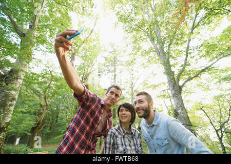 Multi-etnico gruppo di amici prendendo selfie presso un campeggio Foto Stock