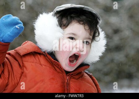 Il toddler boy giocare nella neve Foto Stock