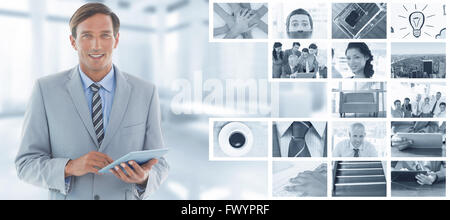 Immagine composita di happy businessman utilizzando tablet pc Foto Stock