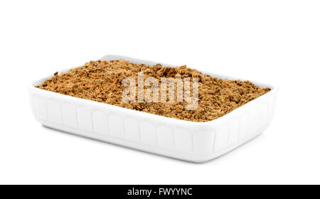 Apple Crumble in un bianco coppa in ceramica isolata su sfondo bianco. Foto Stock