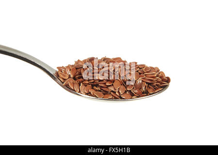 Brown Lino semi su un cucchiaino su sfondo bianco Foto Stock