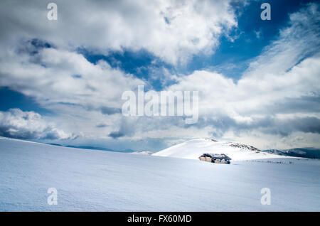 Ovile in montagna in inverno. Stagionale rifugio Pastore. Carpazi, Romania. Foto Stock