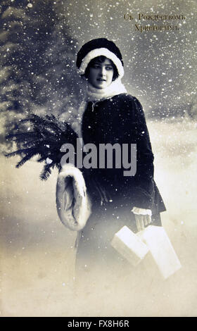 Cartolina stampata in Russia mostra giovane donna sullo sfondo delle cime innevate foresta, circa 1915 Foto Stock