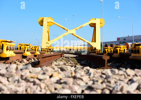 Di colore giallo brillante Treno fermata tampone paraurti o alla fine di un binario ferroviario. Foto Stock