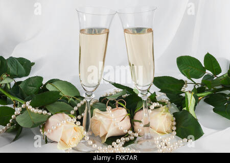 Wineglass, rosa e oro anelli sull'abito, come sfondo Foto Stock